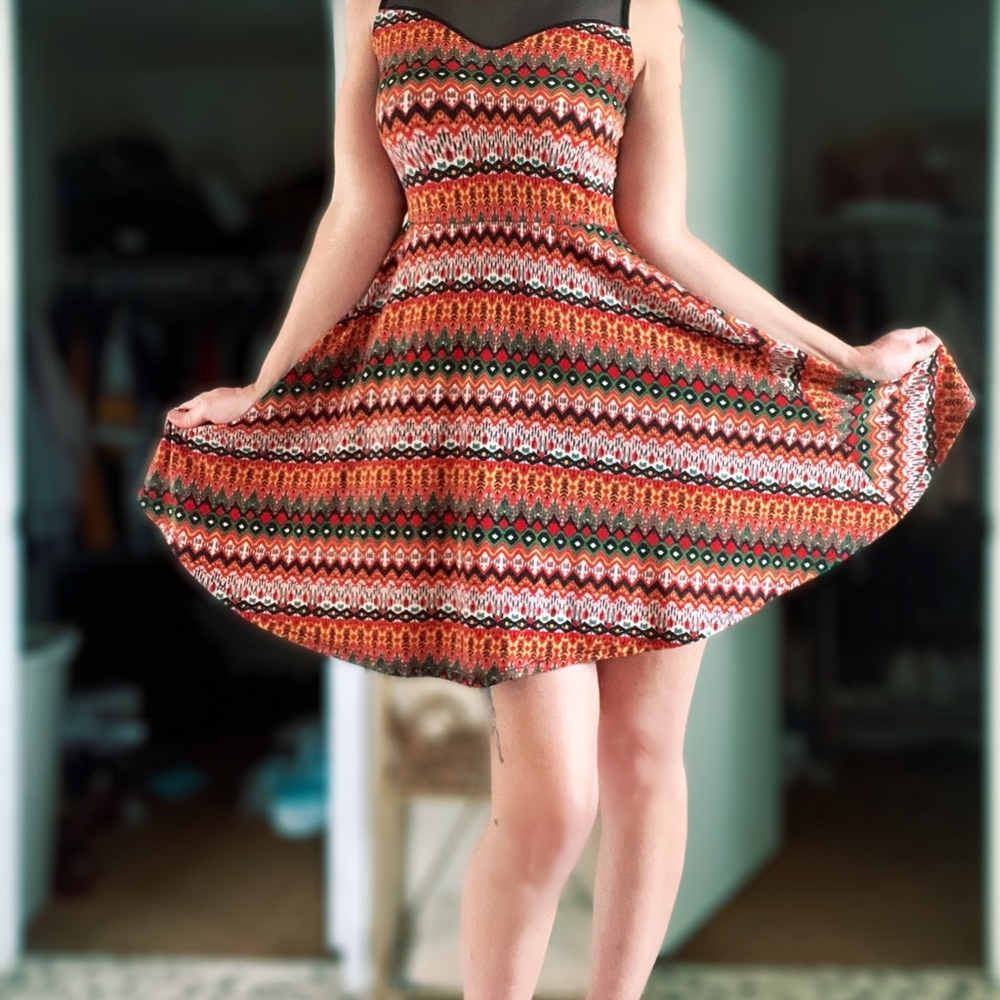 Tribal like print short flowing light dress with black sheer mesh tank style top